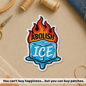 May include: Embroidered patch with the words "ABOLISH ICE" above a blue ice cube design with white trim and a red and orange flame design. The patch is on a beige surface with sewing supplies.