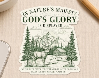May include: A sticker with a nature scene, including a deer, mountains, trees, and a cabin. The text reads "IN NATURE'S MAJESTY GOD'S GLORY IS DISPLAYED." The bottom says "Happiness comes in small sticky pieces."
