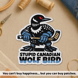 May include: Embroidered patch featuring a cartoon bird with a hockey stick, wearing blue gloves and holding a hockey stick. The patch has the text "STUPID CANADIAN WOLF BIRD" in white. The bird has red eyes and is black and white.