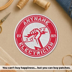 May include: Embroidered red and white patch with the text "ANYNAME ELECTRICIAN" and the year "2025". The patch features a fist holding lightning bolts. The text "EST" is also present.