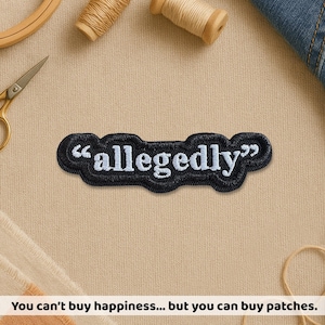 May include: A black embroidered patch with the word "allegedly" in white, surrounded by a black border. The patch is on a beige surface, with sewing supplies in the background. The text "You can't buy happiness... but you can buy patches" is at the bottom.