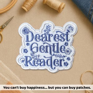 May include: Embroidered patch with the words "Dearest Gentle Reader" in blue script, surrounded by floral designs. The patch has a white border and is on a tan background. The text at the bottom says "You can't buy happiness... but you can buy patches."