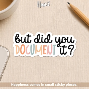May include: A white sticker with the text "But did you DOCUMENT it?" in black, peach, pink, and teal. The sticker is on a beige surface, with a pencil and a coffee cup in the background. The text "Happiness comes in small sticky pieces" is at the bottom.