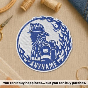 May include: Embroidered patch featuring a blue and white firefighter design within a circular frame. The patch includes the text "ANYNAME" and is surrounded by stylized flames. The image also includes the text: "You can't buy happiness... but you can buy patches."