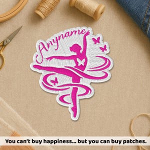 May include: A white embroidered patch featuring a hot pink silhouette of a ballerina in a dance pose, surrounded by pink butterflies and ribbons. The text Anyname is stitched in pink script above the dancer on a white background with a border.