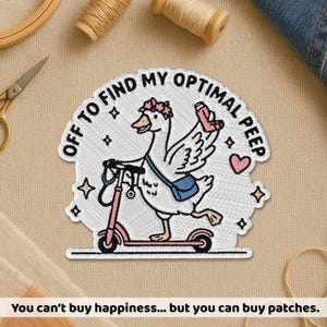 May include: Embroidered patch featuring a goose riding a pink scooter, carrying a drink and a blue bag. Text reads "OFF TO FIND MY OPTIMAL PEEP." Additional text at the bottom says "You can't buy happiness... but you can buy patches."