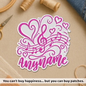 May include: A white embroidered patch featuring a vibrant hot pink design of a treble clef, musical staff lines, and several hearts. The word "anyname" is stitched in a cursive hot pink font at the bottom of the patch, which has a die-cut edge.