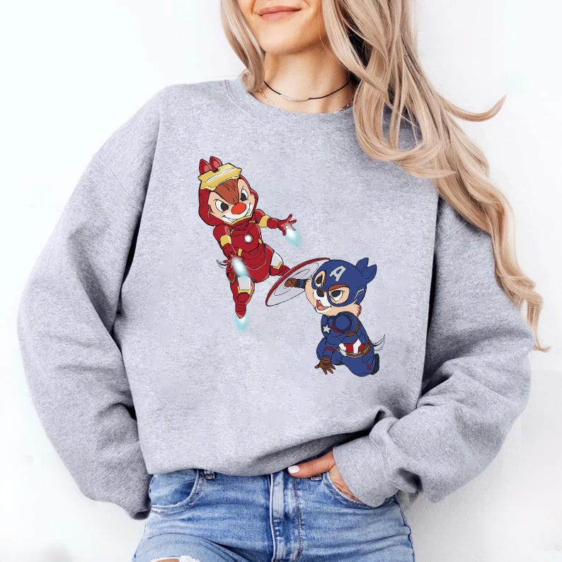 May include: A gray sweatshirt with a cartoon image of two chipmunks dressed as superheroes. One chipmunk is dressed as Iron Man and the other is dressed as Captain America.