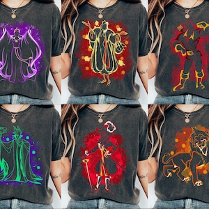 May include: Six different t-shirts featuring various Disney villains in a minimalist style. The villains are depicted in a silhouette with a splash of colour behind them. The t-shirts are all black with a distressed look.