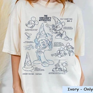 May include: A white t-shirt featuring a blue outline drawing of Mickey Mouse as the Sorcerer's Apprentice from the 1940 Disney film Fantasia. The drawing includes instructions for animators, such as "Keep sleeves loose and play with movement" and "Notice how black part of head alters as Mickey changes expressions". The text "The Sorcerer's Apprentice - 1940 -" and "Walt Disney Prod RX-1" are also included in the design.