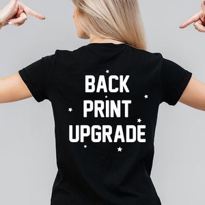 May include: Black t-shirt with white text that reads "BACK PRINT UPGRADE" and white stars around the text.