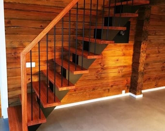 May include: A wooden staircase with black metal railings. The stairs are made of dark wood and have a modern design. The stairs are against a wall of wood planks.