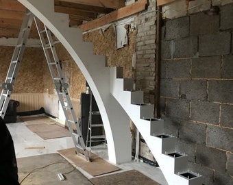 May include: A white, modern staircase under construction, featuring a curved design and square steps. The staircase is set against a backdrop of exposed brick and wooden beams, with a metal ladder leaning against it.