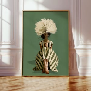 May include: A framed wall art print featuring a stylised illustration of a person sitting on a solid green background. The person wears a dress with vertical olive green and cream stripes and holds a large, round, beige dried palm leaf fan.