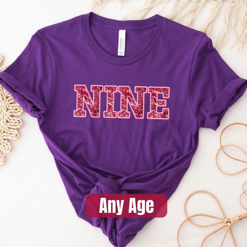 a purple shirt with the word nine printed on it