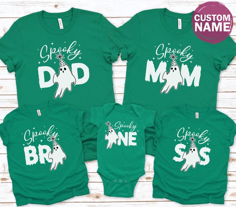 a collection of green t-shirts with the word "Spooky" printed on them, along with various ghost-related designs.