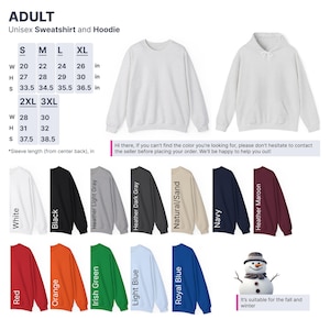 a white sweatshirt with a snowman on the front and a snowman on the