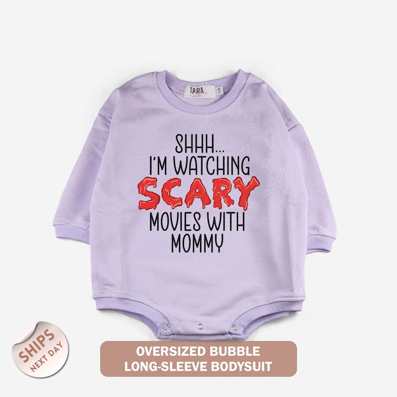 a baby bodysuit with the words, i'm watching scary movies with mommy