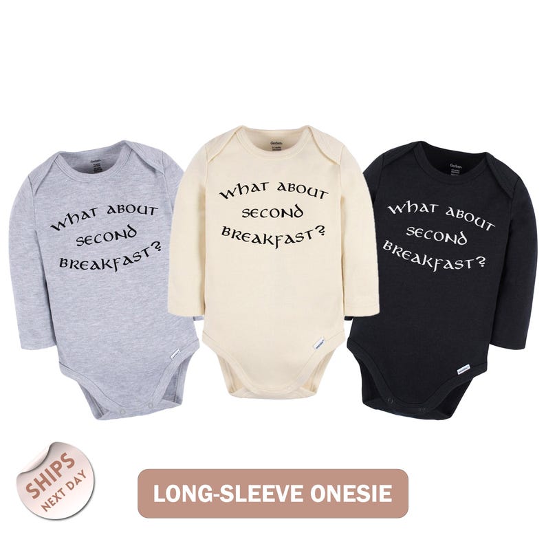 Three long-sleeve onesies with the same text printed on them, arranged in a row.