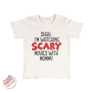 a white t - shirt with the words scary movies with mommy printed on it