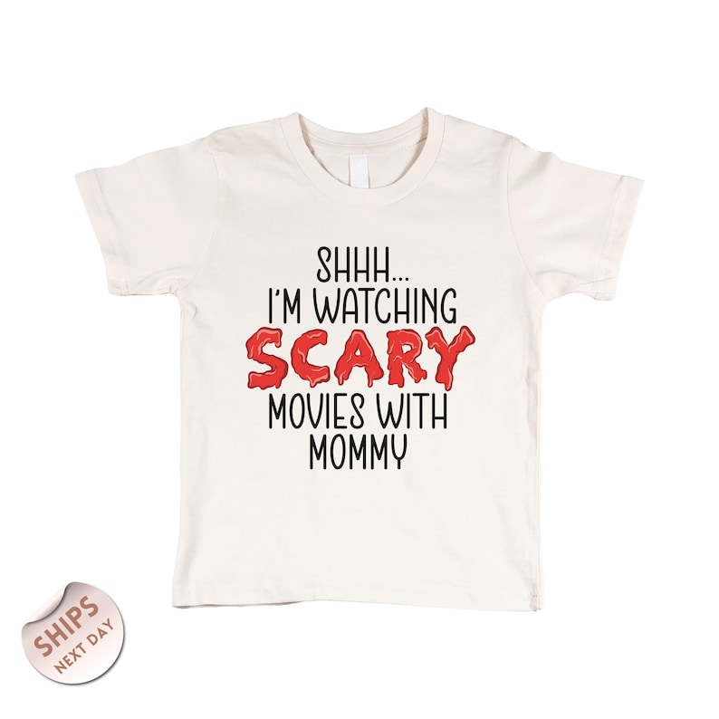 a white t - shirt with the words scary movies with mommy printed on it