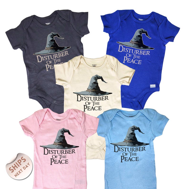 six baby onesies with the same design, featuring a witch's hat and the text "Disturb of the Peace".
