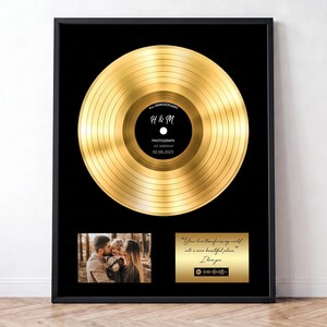 May include: A framed gold vinyl record display featuring a central black label with the text 4th ANNIVERSARY, H & M, PHOTOGRAPH, ED SHEERAN, 02.08.2023. Below is a photograph of three people and a gold plaque with text and a scannable music code.