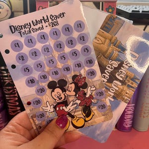 May include: A Disney World Saver card featuring Mickey and Minnie Mouse. The card includes circles with values from £1 to £20, and the text "Disney World Saver" and "Total Saved = £268".