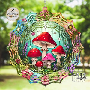 May include: A colorful, whimsical hanging decoration featuring a mushroom design. The artwork includes red and pink mushrooms with white spots, surrounded by flowers and foliage. The text "2 Free Designs Included" is visible.