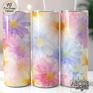 May include: Three stainless steel tumblers with a floral design. The tumblers feature a watercolour-style pattern of pink, purple, and blue flowers. The tumblers are all the same size and shape.