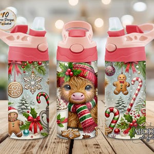 May include: Three water bottles with pink lids and straw spouts featuring a Christmas theme. The design includes a fluffy highland cow wearing a red hat and scarf, gingerbread cookies, candy canes, snowflakes, holly, and red bows on a snowy background.