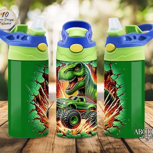 May include: Three green water bottles with blue and green lids. The bottles feature a green dinosaur and monster truck design. The bottles have the text "10 Free Designs Included" and "ABODE art digital".
