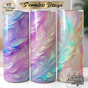 May include: Three tall, cylindrical tumblers with a seamless feather design in shades of purple, blue, and iridescent colours. The tumblers have a glossy finish. Text on the image reads "10 Free Designs Included" and "Seamless Design". The logo "ABODE art digital" is also visible.