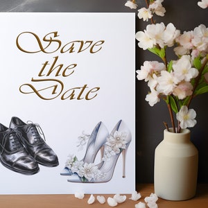 May include: A wedding invitation card with the words "Save the Date" in gold script. The card features illustrations of black dress shoes and white high heels adorned with flowers. A vase of white flowers is to the right.