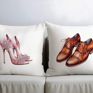 May include: Two decorative cushions on a white sofa. One cushion features a watercolour illustration of pink high heels with floral embellishments. The other cushion displays a watercolour illustration of brown leather dress shoes.