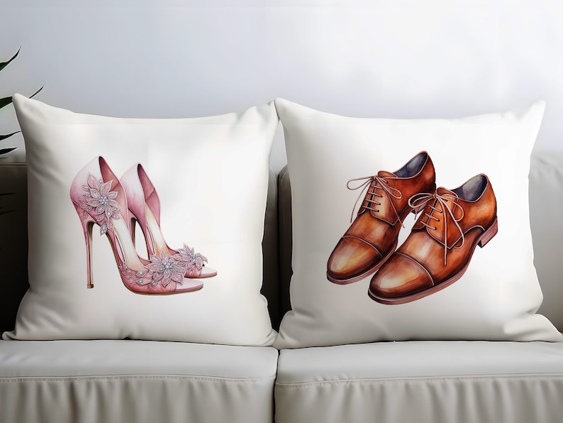 May include: Two decorative cushions on a white sofa. One cushion features a watercolour illustration of pink high heels with floral embellishments. The other cushion displays a watercolour illustration of brown leather dress shoes.