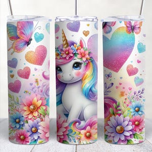 May include: A white unicorn with a rainbow mane and tail, wearing a flower crown, surrounded by colorful flowers and hearts. The background is white with glitter accents.