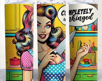 May include: A stainless steel tumbler with a pop art design featuring a woman holding a knife in a kitchen setting. The text "COMPLETELY unhinged" is in a speech bubble above her head.