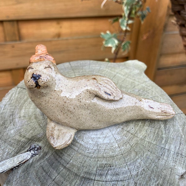 Harbour seal in hat, whimsical ceramic sculpture, funky seal