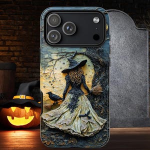 May include: A phone case with a 3D design of a witch in a black hat and dress, holding a broom, with a raven. The background shows a tree and full moon. A pumpkin and witch hat are visible in the background, evoking a Halloween theme.