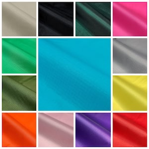 May include: A selection of fabric swatches in a range of colours: beige, black, dark green, hot pink, green, teal, grey, olive green, yellow, orange, light pink, purple, and red. The fabric has a subtle grid pattern.