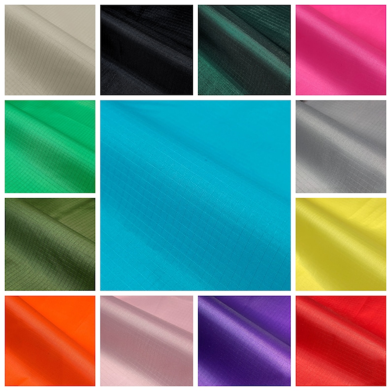 May include: A collection of fabric swatches in various colors, including beige, black, dark green, hot pink, green, teal, gray, olive green, yellow, orange, light pink, purple, and red. The fabric has a subtle grid pattern.