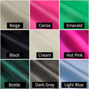 May include: A collection of fabric swatches in various colors, including beige, cerise, emerald, black, cream, hot pink, bottle green, dark grey, and light blue. Each swatch has a label with its color name.