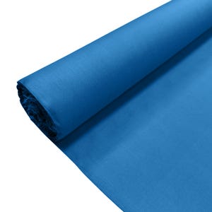 May include: A large roll of solid blue fabric featuring a smooth, matte texture. The material is tightly wound into a cylindrical shape at one end, with the remaining length of the vibrant blue textile extending outward across the frame.