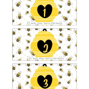 May include: Three rectangular cards with a bee theme. Each card features a yellow beehive with a black heart shape containing the numbers 1, 2, and 3. The background is white with cartoon bees.