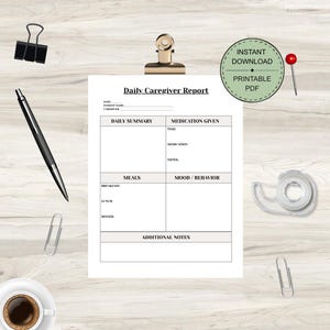 May include: A printable PDF daily caregiver report with sections for daily summary, medication, meals, and mood/behavior. Includes a pen, paper clips, a coffee cup, a push pin, a tape dispenser, and a binder clip. The report is labeled "Daily Caregiver Report".