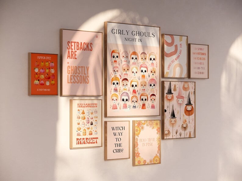 May include: A wall gallery featuring nine framed prints with Halloween-themed illustrations and text. The prints feature a variety of designs, including pumpkins, ghosts, witches, and skeletons. The text on the prints includes phrases like "Setbacks are ghostly lessons", "Girly Ghouls Night In", and "Witch Way to the Crib?"