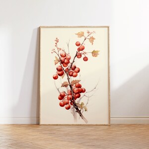 May include: A watercolor painting of a branch with red berries and leaves. The painting is framed in a light wood frame and is hanging on a white wall.