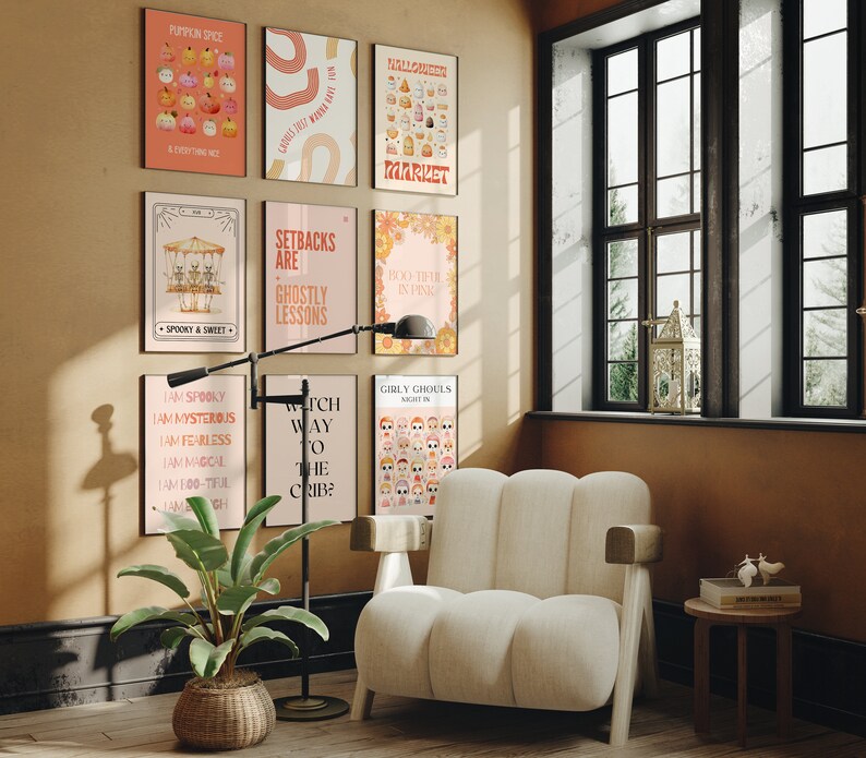 May include: A living room corner with a white armchair and a floor lamp. The wall is decorated with nine colorful posters with Halloween-themed illustrations and text. The posters include phrases like "Spooky & Sweet", "Girly Ghouls", "Boo Their In Pink", and "Setbacks Are Ghostly Lessons".