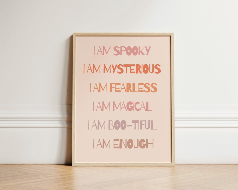May include: A framed print with a pink background and white text that reads "I am spooky, I am mysterious, I am fearless, I am magical, I am boo-tiful, I am enough".